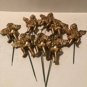 8 vintage plastic gold cherubs with removable sticks for your crafting needs.